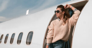woman-passenger-in-sunglasses-standing-on-airplane